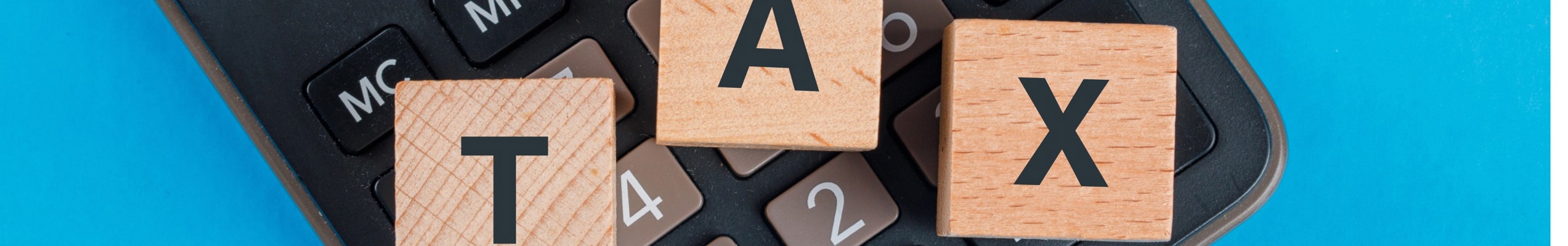 Tax Planning Concept With Wooden Cubes Calculator Blue Table Flat Lay (1)